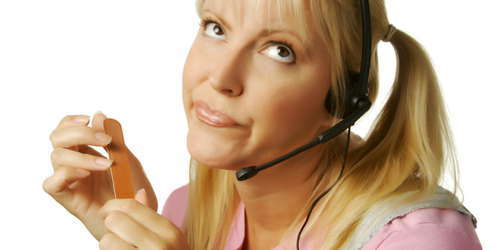 A woman with a headset looks up with a bored expression while filing her nails. She has blonde hair in pigtails and is wearing a pink shirt. The background is plain white.