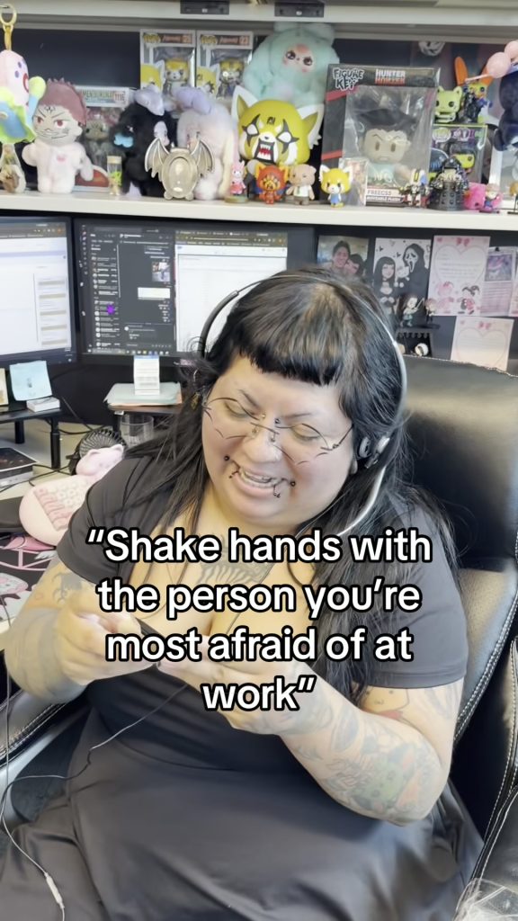 A receptionist wearing a headset laughs at her desk in the Abby Connect office
