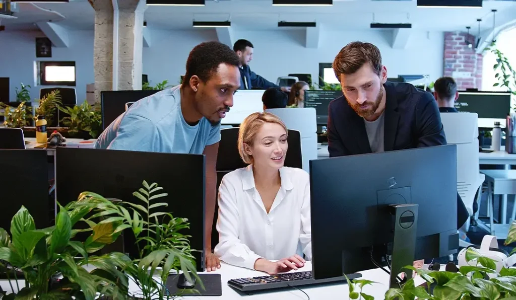 Team collaborating in modern office workspace illustrating domain expertise and AI technology working together to solve business challenges
