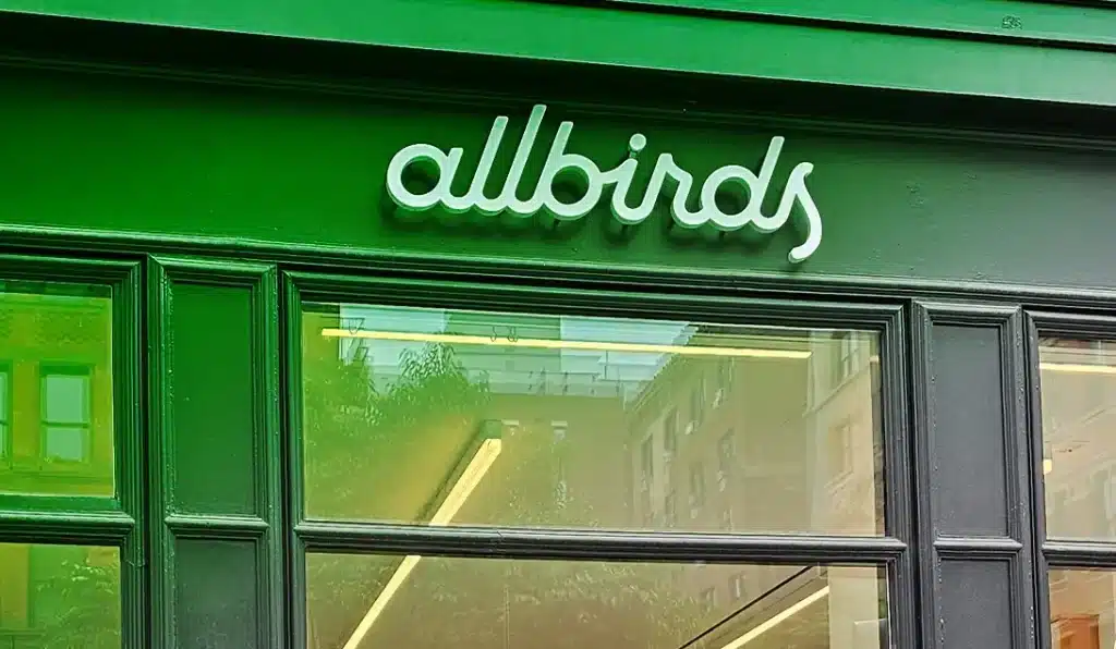 AI washing example featuring Allbirds storefront sign used to illustrate companies rebranding with artificial intelligence buzzwords without real AI expertise