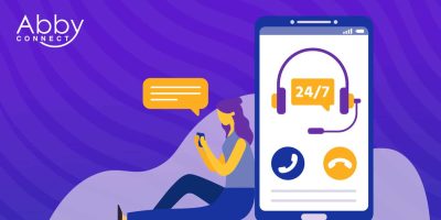 Illustration of a woman sitting and using her phone, with a large smartphone screen showing a headset icon labeled 24/7 and phone call icons. Abby Connect logo appears in the top left corner.