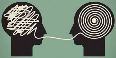 Two black silhouettes of heads facing each other. One head contains a chaotic scribble, while the other contains a neat spiral, connected by a line representing communication and understanding.