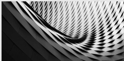 customer_service_blog_66 Abstract architectural structure with a repeating pattern of interwoven, diamond-shaped tiles creating a curved, undulating surface in black and white tones. Light and shadow enhance the three-dimensional effect.